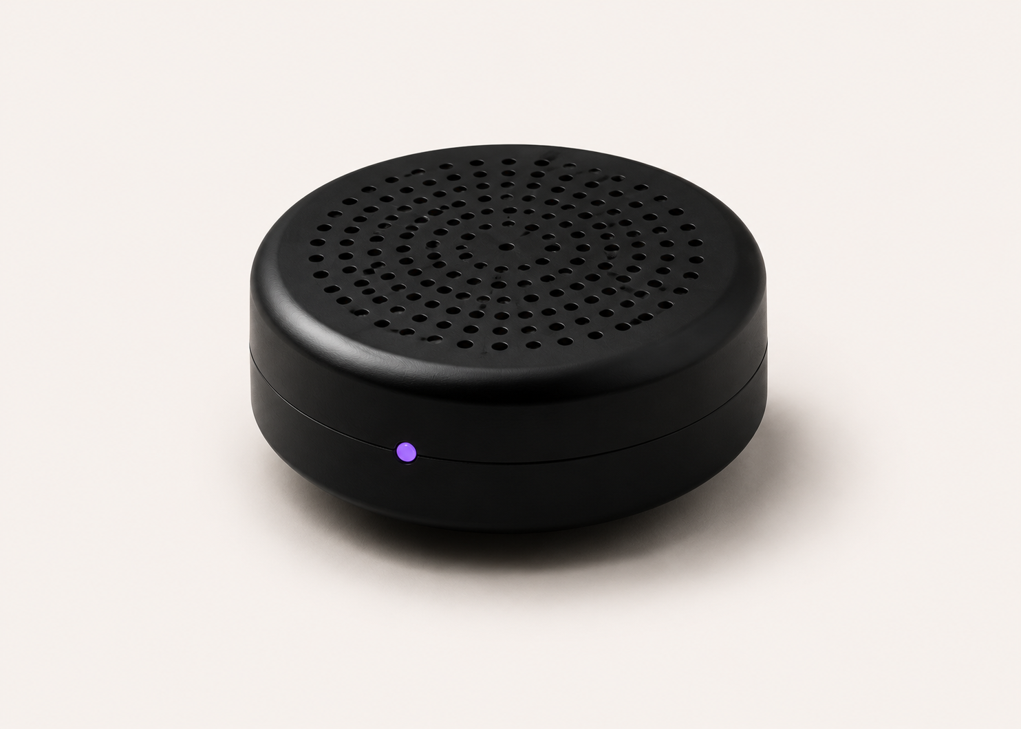 Free Clicker ambient mic — circular matte black puck with perforated grille and status LED